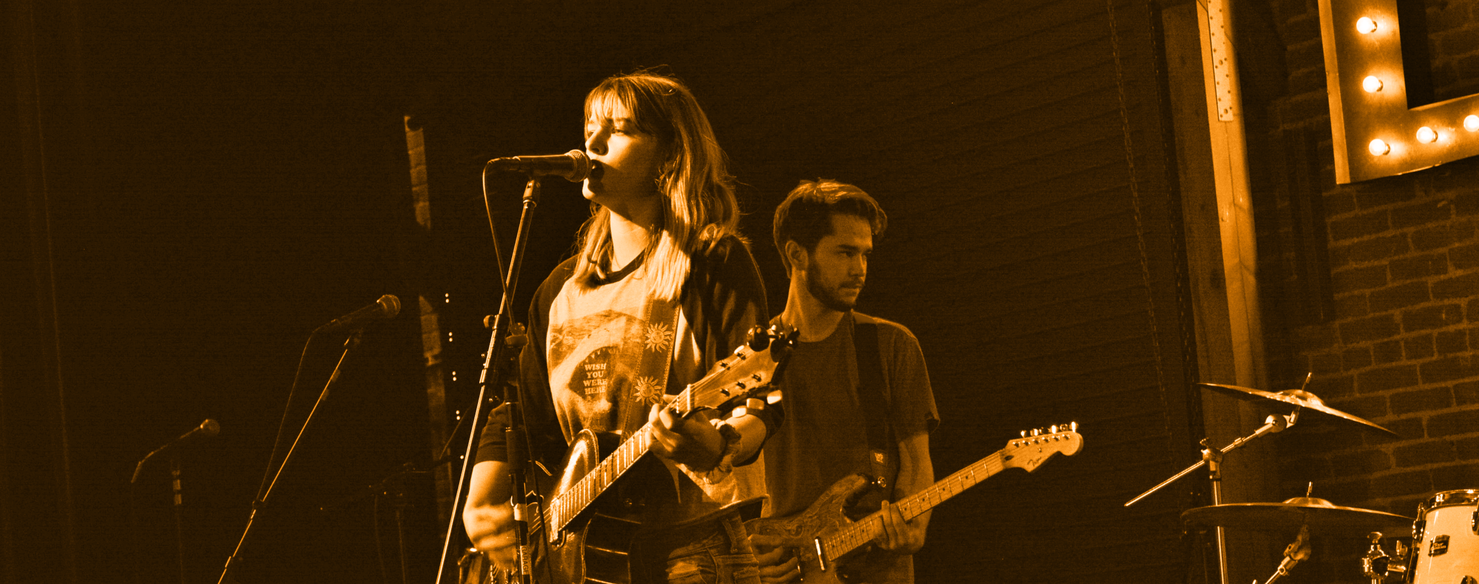 Two student on guitar performing on stage