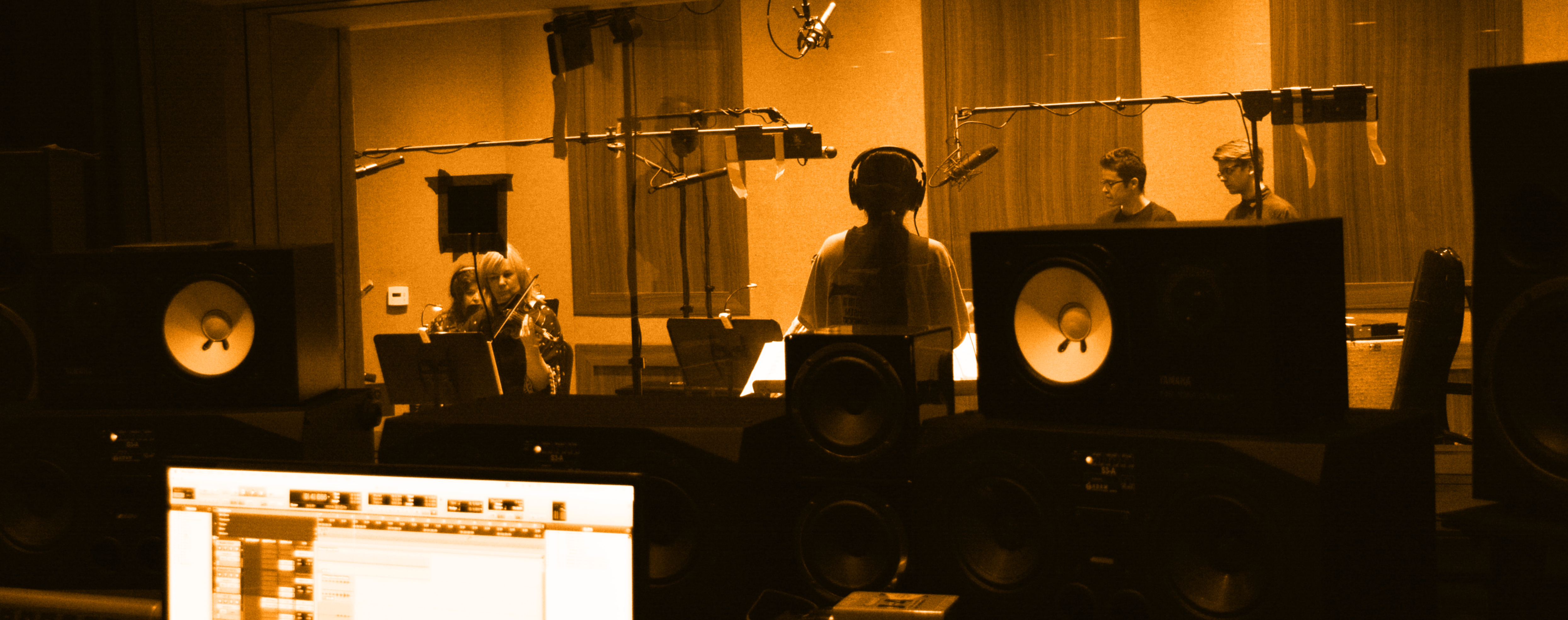 CVM Final Student conducting small orchestra in studio