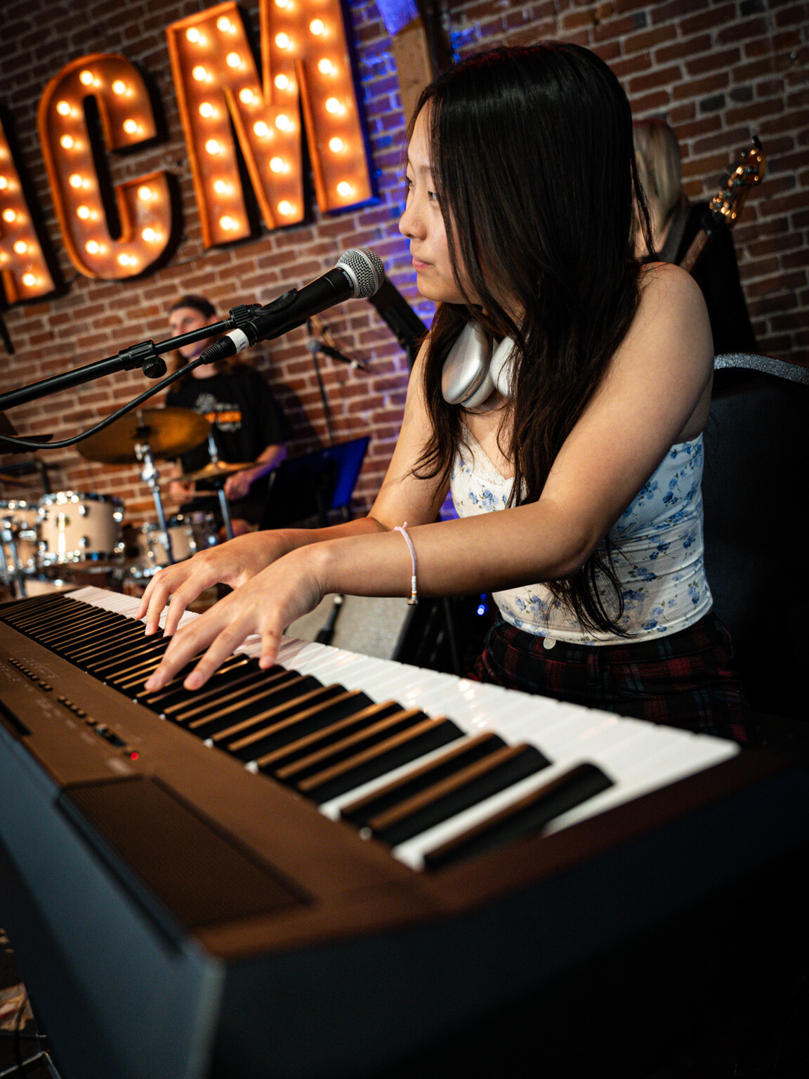 Girl at piano with headphones
